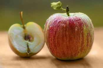 red apple, green apple, brown surface, wooden surface, fresh apple, dew drops, sliced apple, close-up, apple half, apple core, fruit photography