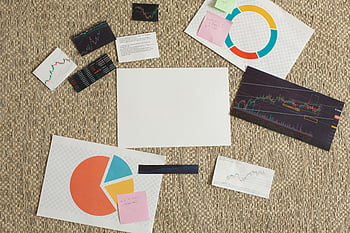financial charts, sticky notes, textured surface, flat lay, planning concepts, analysis concepts, paper graphs, straw surface, pie chart, financial analysis