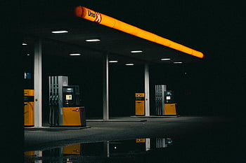 Here are the most relevant photo keywords for SEO based on the provided caption, description, and the image:

1. moody nighttime gas station
2. empty gas station
3. orange lights
4. nighttime photography
5. urban landscape
6. gas station lights
7. atmospheric lighting
8. nocturnal scene
9. reflective surface water

These keywords capture the essence of the photo's mood, lighting, and setting.