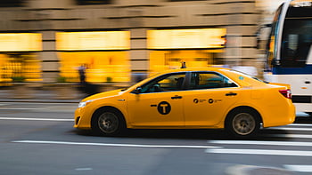 New York City, yellow taxi, urban streets, city life, taxi overtaking bus, motion blur, cityscape, public transportation, city traffic, yellow cab, urban environment