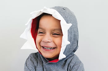 boy-smiling-grey-and-white-hoodie-shark-themed-hoodie-cute-child-joyful-smile-playful-themes-happy-themes-child-wearing-hoodie-shark-hoodie-happy-boy-thumbnail.jpg