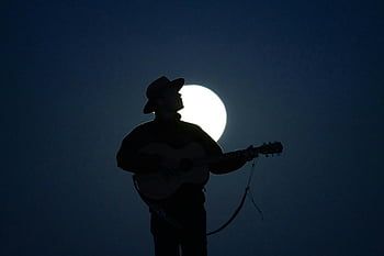 man playing guitar, acoustic guitar, moonlight, cowboy, silhouette, dramatic scene, musical scene, night, full moon, outdoor, musician