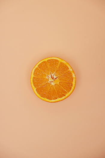 sliced orange, top view, white surface, vibrant colors, fresh orange, beige background, orange fruit, orange slice, fruit texture, citrus fruit, orange segment