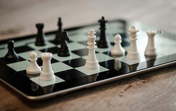 tilt shift lens, black and white chess pieces, close-up chess game, tablet chess, chess strategy, technology chess, chess pieces, chess board, digital chess, chess game, chess strategy game