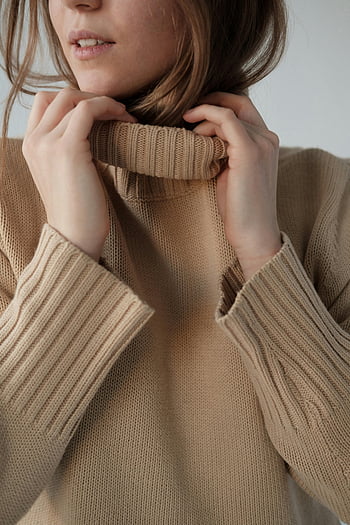 young woman, soft sweater, beige sweater, warm knit textures, close-up portrait, indoor studio, knit textures, studio portrait, woman in sweater, indoor photography, warm sweater