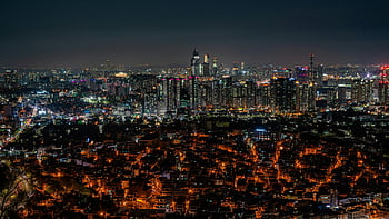 Seoul skyline, night view, illuminated skyscrapers, bustling cityscape, aerial view, urban landscape, city lights, night photography, metropolitan scene, South Korea, city panorama