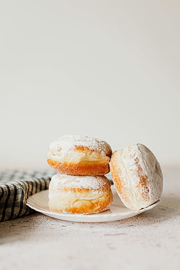 powdered sugar donuts, stack of donuts, fluffy donuts, dessert enthusiasts, plate of donuts, powdered sugar, sweet treats, donut stack, dessert plate, delicious donuts, fluffy treats