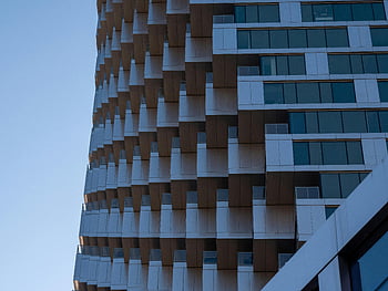 modern high-rise building, Vancouver architecture, innovative design, contemporary architecture, urban landscape, geometric pattern, glass windows, skyscraper, cityscape, dynamic architecture, urban design
