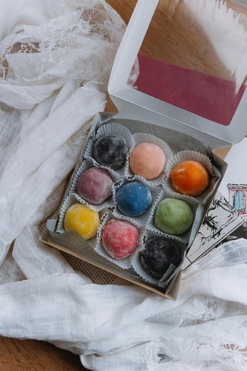 colorful mochi, mochi dessert, vibrant mochi, food photography, assorted mochi, mochi in box, dessert box, colorful dessert, mochi variety, mochi treats, mochi assortment