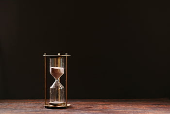 hourglass, macro shot, sand trickling, passage of time, dark background, classic hourglass, time symbol, sand timer, time measurement, glass hourglass, sand flow