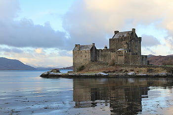 Eilean Donan Castle, Scottish Highlands, water reflection, serene landscape, historic castle, lake view, concrete structure, majestic architecture, natural beauty, winter scene, tranquil setting