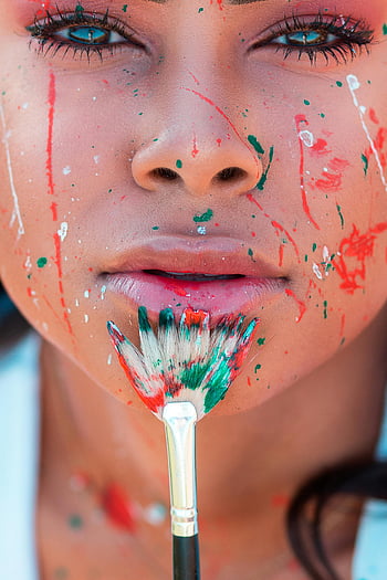 close-up photo, woman's face, colorful paint, brush, artistic close-up, face paint, paintbrush, artistic portrait, woman portrait, colorful makeup, artistic makeup