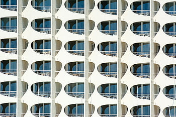 modern building exterior, geometric patterns, architectural design, modern architecture, building facade, blue windows, contemporary design, balcony architecture, abstract patterns