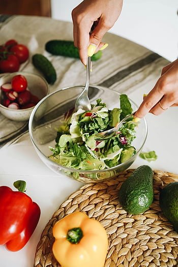 green vegetable salad, glass bowl, fresh vegetable salad, cucumbers, peppers, lettuce, kitchen setting, hands preparing salad, healthy eating, vegetarian meal, salad preparation