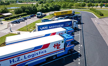 drone shot, trucks, logistics trucks, aerial image, rest area, parked trucks, H.Z. Logistics, Van Miechem, DACHSER, rest stop, logistics vehicles