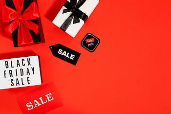 Black Friday, sale, red background, flatlay, gifts, tags, copy space, discount, shopping, holiday deals, promotions