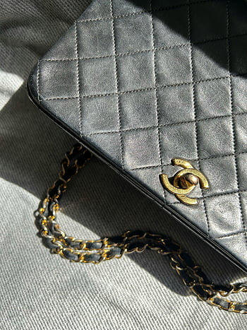 black leather bag, luxury handbag, quilted leather, gold chain strap, close-up, black handbag, quilted handbag, gold logo, designer bag, high-end handbag, fashion accessory