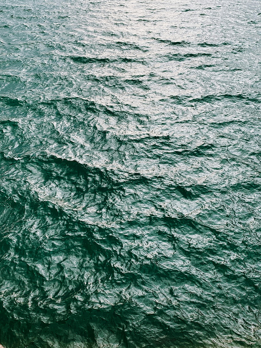 ocean waves, close-up shot, tranquil view, glistening water, daylight reflection, soothing atmosphere, seaside scene, ocean surface, natural beauty, water texture, calm waters