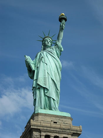 Statue of Liberty, New York City, symbol of freedom, clear blue sky, iconic landmark, American symbol, Lady Liberty, national monument, tourist attraction, copper statue, crown spikes