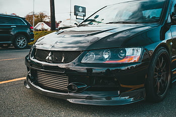Mitsubishi sports car, carbon fiber detailing, sleek design, close-up, front view, selective focus, sport car, Mitsubishi, carbon fiber, car design, sports car