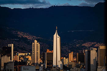 Medellin skyline, Coltejer building, sunset view, Medellin Colombia, cityscape, dramatic sunset, iconic building, urban landscape, sunset skyline, Medellin city, Colombian architecture