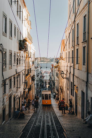 vintage tram, narrow street, Lisbon, Portugal, vintage charm, tram travel, cityscape, urban scene, historic tram, European city, street view