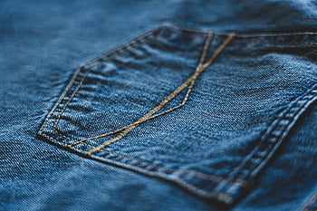 blue denim jeans, close-up view, macro shot, intricate stitching, denim fabric, detailed texture, fashion photography, textile design, clothing detail, jeans pocket, denim stitching