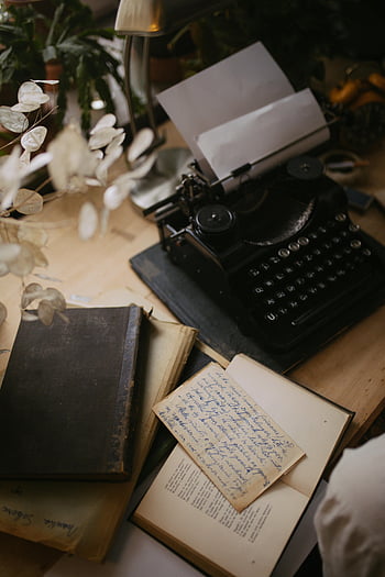 black typewriter, bond paper, wooden table, vintage writing desk, handwritten notes, cozy desk, creativity space, old books, typewriter desk, vintage books, handwritten letters