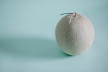 Japanese melon, honeydew melon, blue background, fresh appeal, natural appeal, single melon, fruit photography, melon texture, blue backdrop, fresh fruit, natural fruit