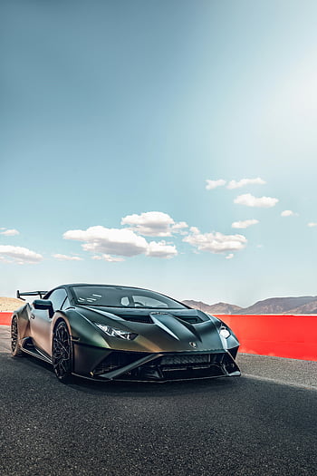 Black Lamborghini, open track, clear blue sky, sleek design, racing car, high-performance vehicle, sports car, automotive photography, luxury vehicle, track day, supercar