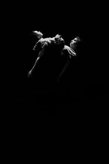 black and white dance, expressive performance, actors in darkness, elegance in dance, artistry in movement, dance scene, black and white photography, dark background, performing together, expressive art, dance artistry