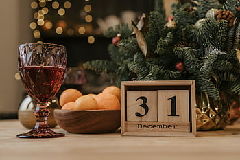 New Year's Eve, festive scene, red wine, December 31, holiday decor, Christmas tree, celebration, festive atmosphere, New Year's celebration, holiday season, festive table setting