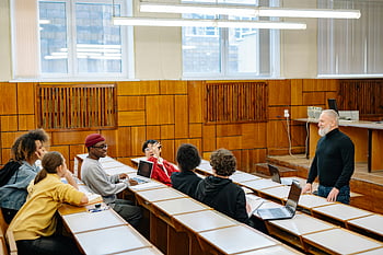 class discussion, university students, diverse classroom, engaging discussion, professor, laptops, educational setting, interactive learning, group discussion, classroom environment, academic discussion