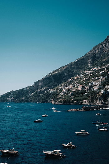 Amalfi coastline, coastal town, stunning aerial view, boats, picturesque scenery, sea coast, hillside town, Mediterranean landscape, Italian coast, scenic view, waterfront town