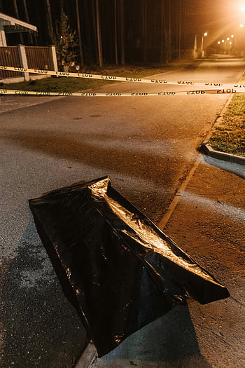 crime scene, police tape, evidence bag, black plastic, urban crime, streetlights, night scene, crime scene investigation, outdoor crime scene, crime scene photography, crime scene evidence