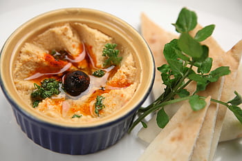 fresh hummus, pita bread, creamy hummus, homemade hummus, pita slices, olive garnish, herbs, close-up, dip, Mediterranean food, appetizer