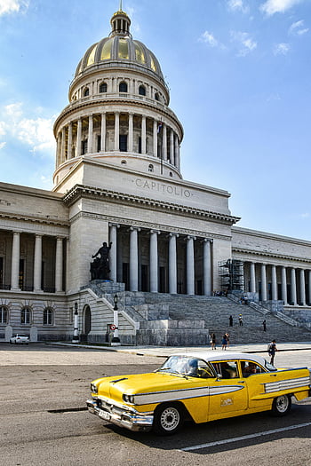 vintage yellow car, El Capitolio, Havana, Cuba, classic car, National Capitol, clear blue sky, historic building, tourist attraction, Caribbean architecture, yellow taxi