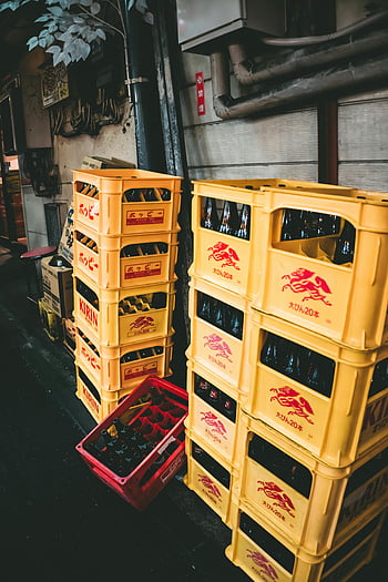yellow plastic crates, red plastic crates, beer crates, Tokyo alleyway, urban storage, stacked crates, yellow crates, red crates, urban scene, Japanese crates, Kirin beer