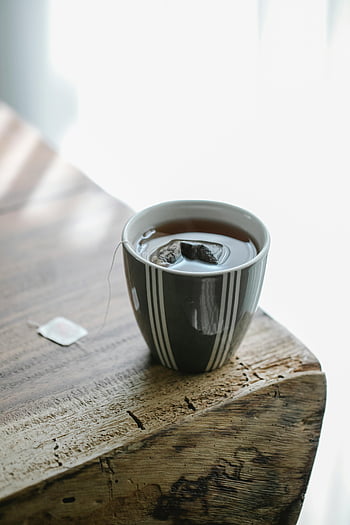 cup of tea, teabag, rustic table, warm tea, calm morning, wooden table, tea cup, tea time, cozy drink, hot beverage, striped cup