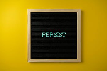 letter board, Persist, vibrant yellow background, determination, close-up shot, text in frame, motivational quote, yellow background, letterboard message, inspirational text, framed text