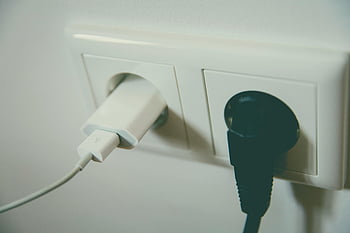electric plug, wall outlet, black plug, white plug, close-up view, electrical connectivity, simplicity, two plugs, inserted, outlet, connectivity