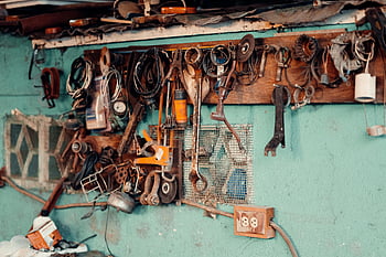 tools on wall, vintage tools, rustic workshop, workshop decor, nostalgic atmosphere, creative workshop, tool collection, wall-mounted tools, DIY tools display