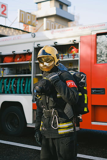 firefighter, protective gear, fire engine, outdoors, equipped fire truck, emergency response, fire safety, fire department, fireman, rescue, fire equipment