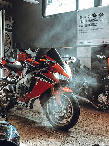 red Honda motorcycle, vibrant red, showroom, sleek design, power, motorcycle, showroom display, red bike, Honda bike, motorcycle showroom, red Honda
