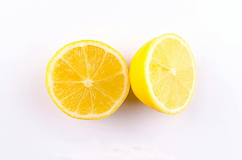 sliced yellow lemon, close-up photo, lemon halves, white surface, fresh lemon, juicy lemon, clean background, citrus fruit, lemon slices, yellow fruit, white background