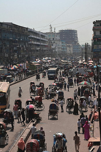 Dhaka street, busy street, rickshaws, cars, pedestrians, Bangladesh, urban scene, city life, traffic, street view, umbrellas
