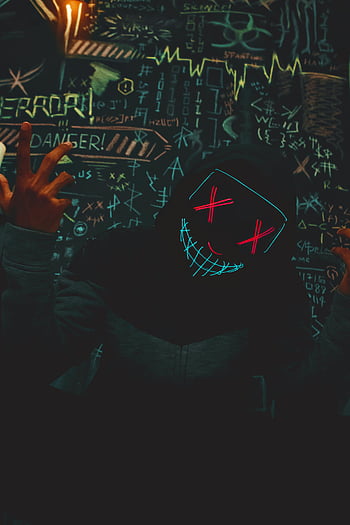Halloween mask, neon mask, creepy mask, dark hooded figure, eccentric graffiti, glowing mask, Halloween costume, spooky mask, neon glow, Halloween decoration, eerie atmosphere