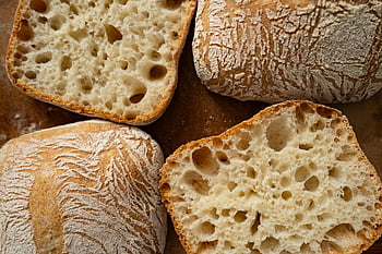 ciabatta bread, sliced ciabatta, freshly baked, airy texture, crispy crust, close-up, bread slices, artisan bread, bakery, food photography, bread crust