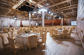 luxurious banquet hall, elegantly set tables, grand event setup, white table, chairs, banquet setting, elegant table setting, event venue, formal dining, wedding reception, event space