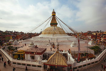 Bouddhanat Stupa, Kathmandu, Nepal, aerial view, architectural grandeur, Buddhist temple, religious site, cultural landmark, spiritual site, golden dome, prayer flags